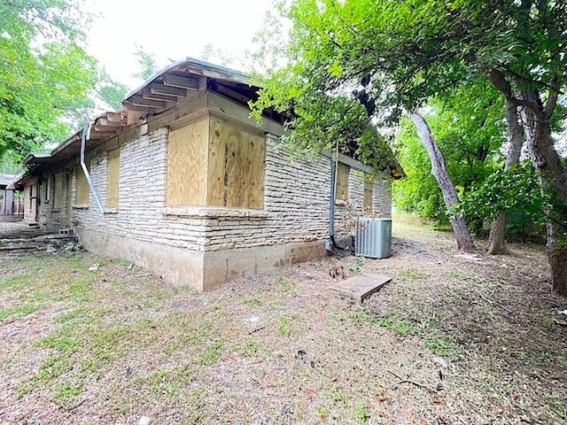 view of side of property with central AC unit