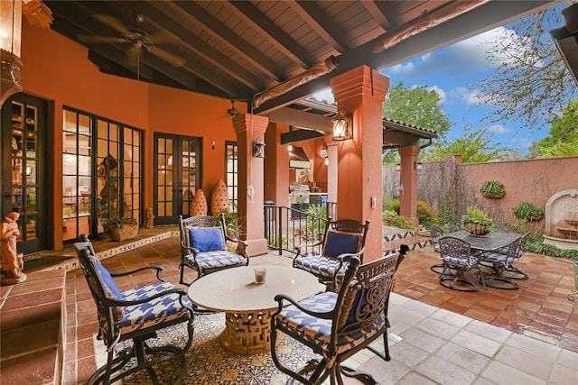 view of patio featuring outdoor dining area, french doors, and fence