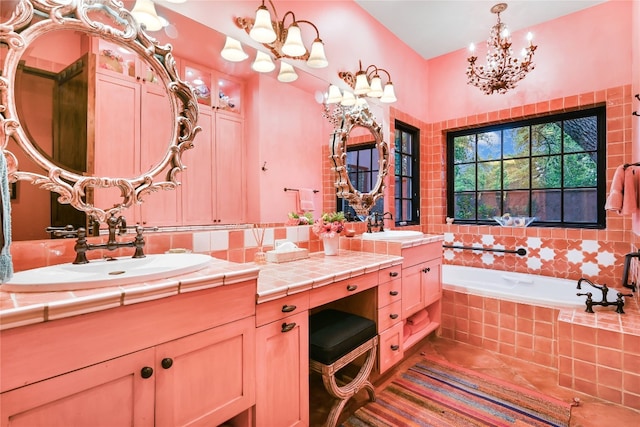 bathroom with tile floors, tiled tub, a notable chandelier, and oversized vanity