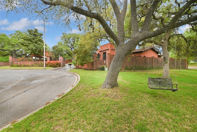 exterior space featuring fence and a front lawn