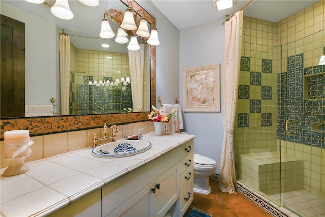 bathroom with a shower with curtain, tile flooring, vanity with extensive cabinet space, and toilet