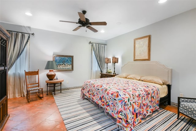 tiled bedroom featuring ceiling fan