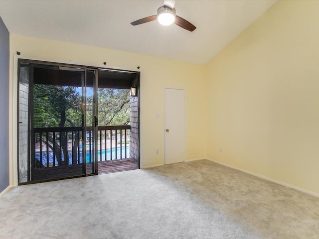 spare room featuring baseboards, lofted ceiling, carpet, and a ceiling fan