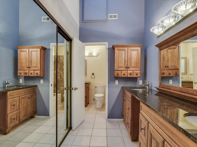 full bathroom featuring a high ceiling, vanity, and toilet