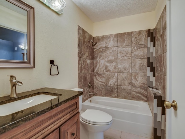 full bathroom featuring a textured ceiling, tile patterned floors, vanity, tiled shower / bath, and toilet