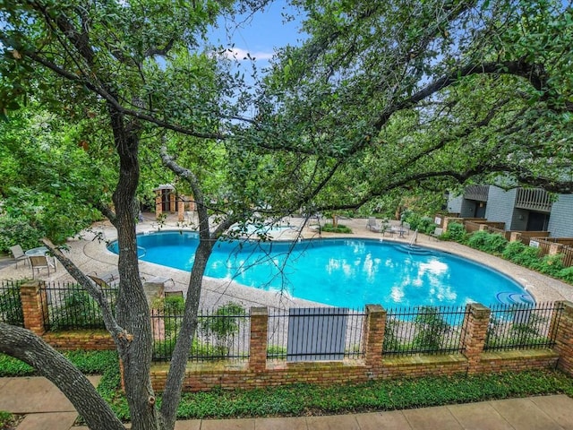 view of pool with a fenced in pool and fence