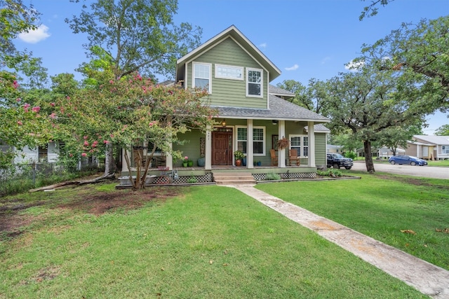 view of front of home with covered porch and a front yard