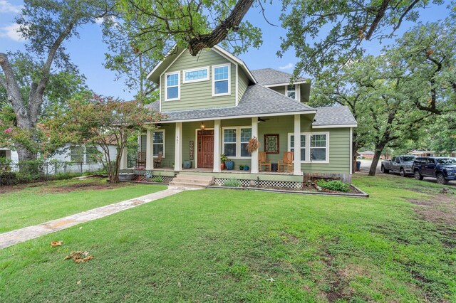 view of front of home featuring covered porch and a front yard