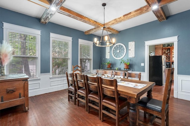 dining room with dark hardwood / wood-style flooring, coffered ceiling, a chandelier, and beamed ceiling