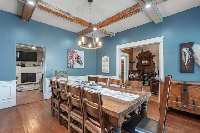 dining room with an inviting chandelier, coffered ceiling, dark hardwood / wood-style floors, and beamed ceiling