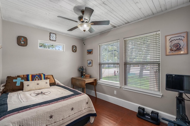 bedroom with ornamental molding, dark hardwood / wood-style floors, and ceiling fan