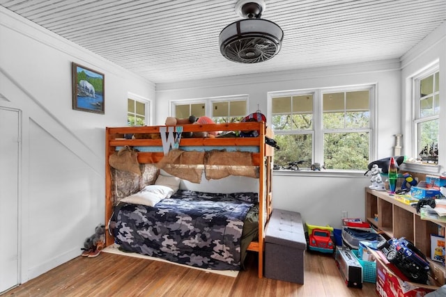 bedroom with hardwood / wood-style flooring and ornamental molding