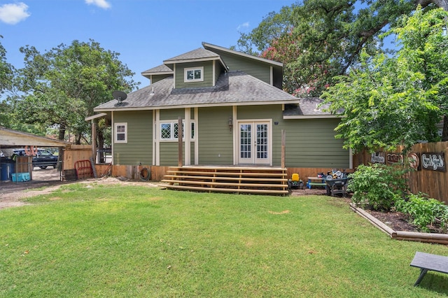 rear view of house with a lawn and french doors