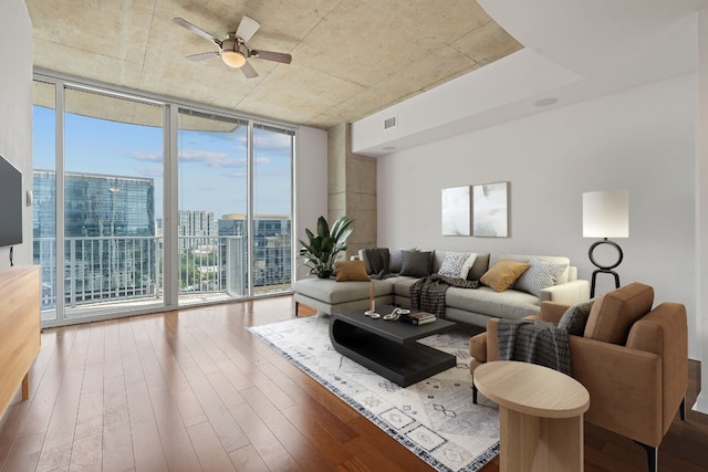 living room with floor to ceiling windows, ceiling fan, hardwood / wood-style floors, and a healthy amount of sunlight