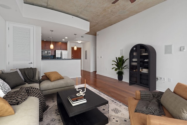 living room featuring ceiling fan and hardwood / wood-style flooring