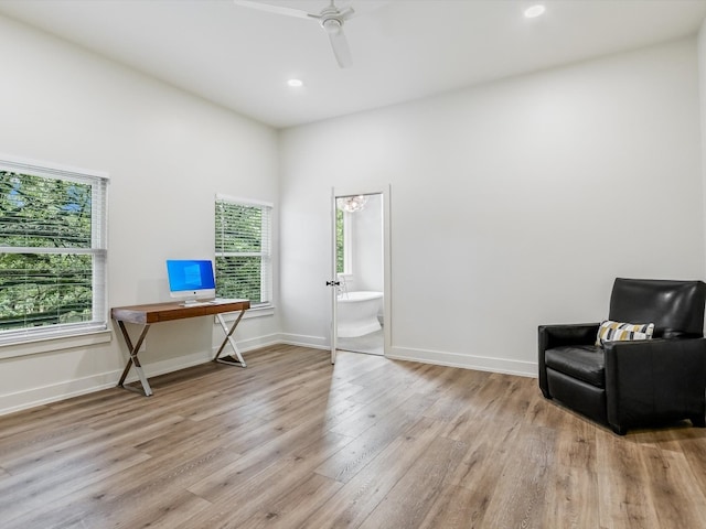 sitting room with ceiling fan, plenty of natural light, and hardwood / wood-style flooring