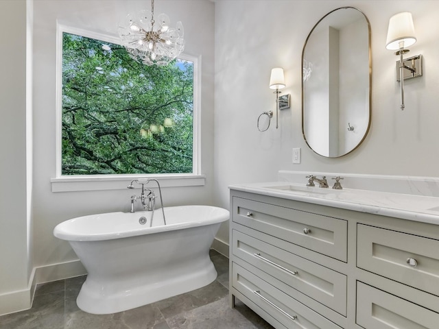 bathroom with a wealth of natural light, an inviting chandelier, vanity, and tile floors