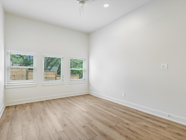 empty room with ceiling fan, light hardwood / wood-style flooring, and a wealth of natural light