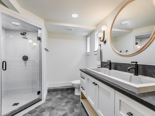 bathroom with walk in shower, toilet, tile floors, and large vanity