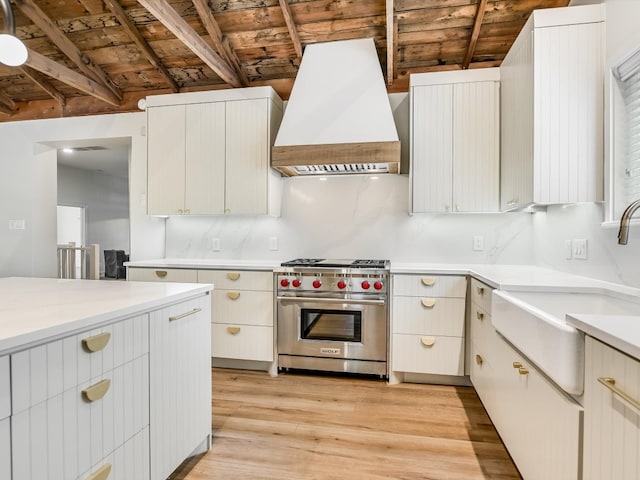 kitchen featuring luxury range, custom exhaust hood, wood ceiling, and light wood-type flooring