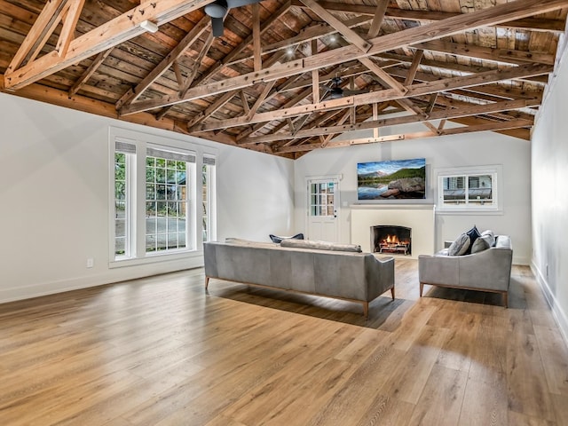 living room with beamed ceiling, wood ceiling, and hardwood / wood-style floors