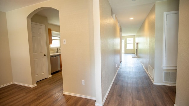 corridor with dark hardwood / wood-style flooring