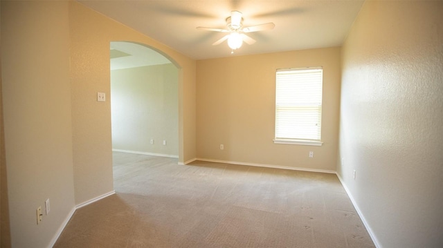 spare room with light colored carpet and ceiling fan