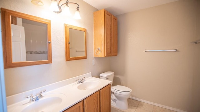 bathroom featuring vanity, toilet, and tile patterned flooring