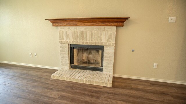 details with wood-type flooring and a brick fireplace