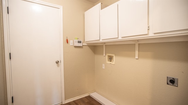 clothes washing area with electric dryer hookup, dark hardwood / wood-style flooring, cabinets, and washer hookup