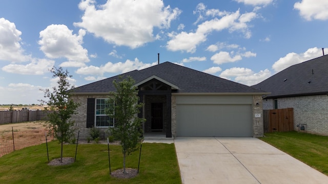 single story home featuring a front lawn and a garage