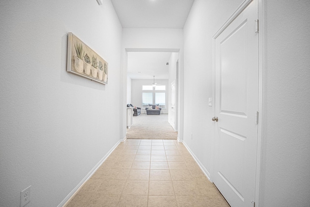 hall featuring light tile patterned floors