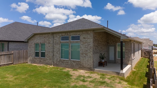 back of house featuring a patio area and a yard