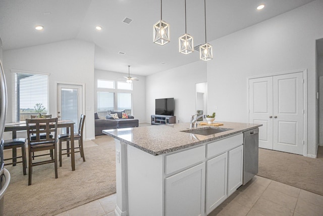 kitchen with light tile patterned floors, an island with sink, ceiling fan, dishwasher, and sink