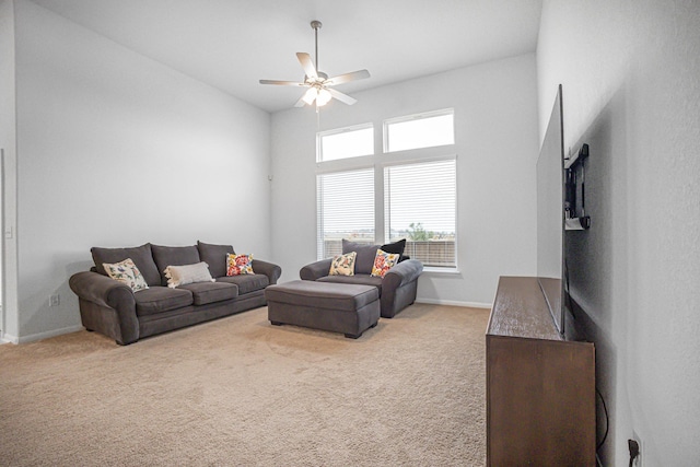 living room featuring ceiling fan and carpet