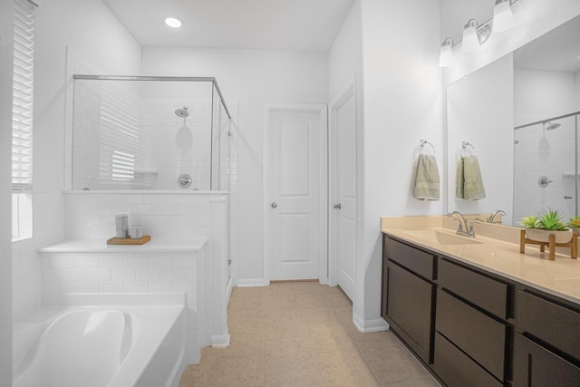 bathroom featuring tile patterned floors, vanity, and separate shower and tub