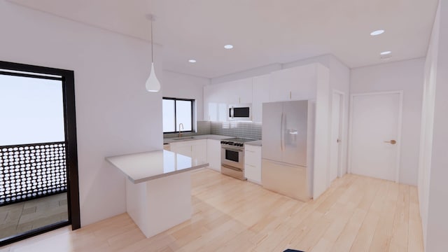 kitchen with light hardwood / wood-style flooring, backsplash, sink, white cabinets, and appliances with stainless steel finishes