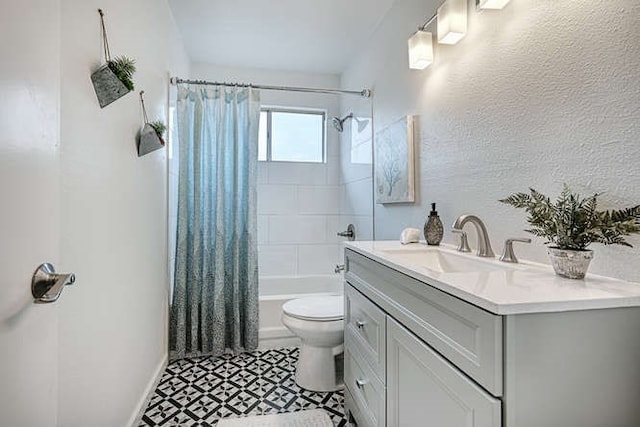 full bathroom featuring shower / bath combo, vanity, and toilet