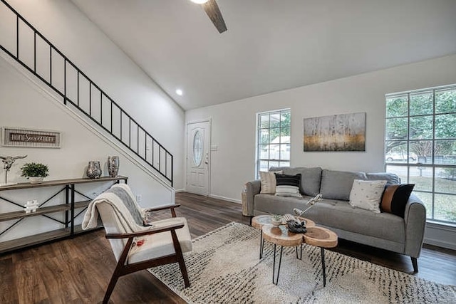 living room with dark wood-type flooring, lofted ceiling, and a healthy amount of sunlight