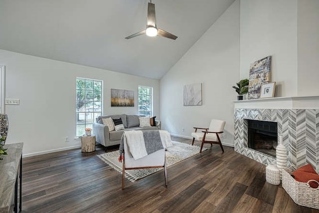 living room featuring a fireplace, dark hardwood / wood-style floors, ceiling fan, and high vaulted ceiling