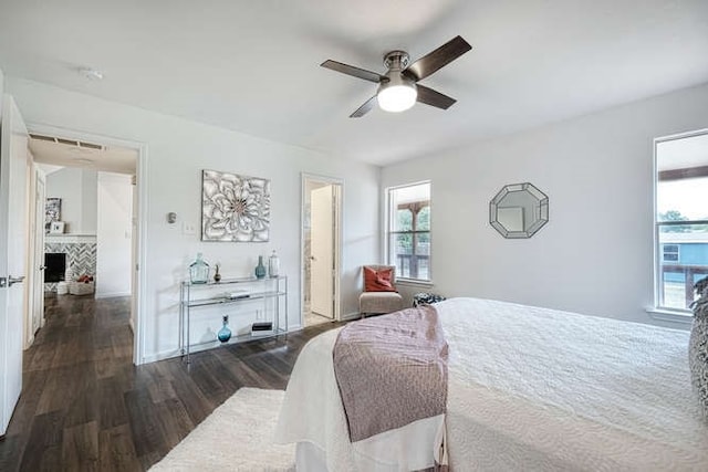 bedroom with multiple windows, ceiling fan, and dark hardwood / wood-style floors