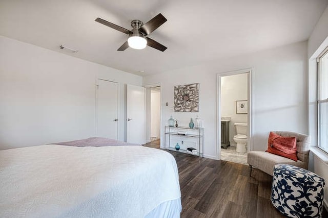 bedroom featuring dark wood-type flooring, ceiling fan, and ensuite bath