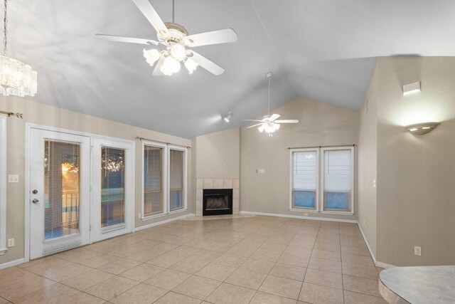 unfurnished living room featuring high vaulted ceiling, ceiling fan, a tile fireplace, and light tile flooring