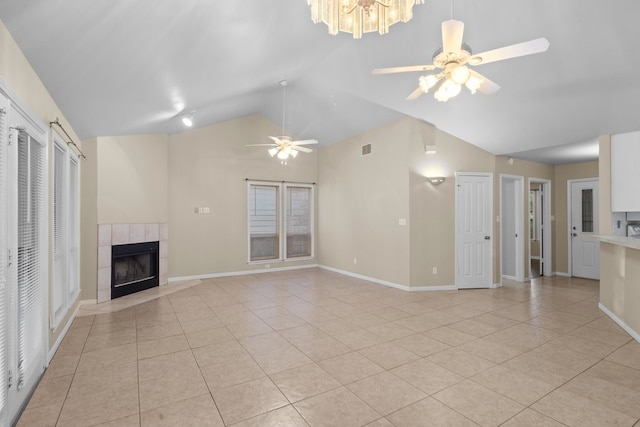 unfurnished living room featuring high vaulted ceiling, a fireplace, ceiling fan, and light tile floors