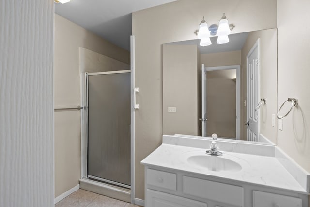 bathroom featuring a shower with door, tile flooring, and vanity