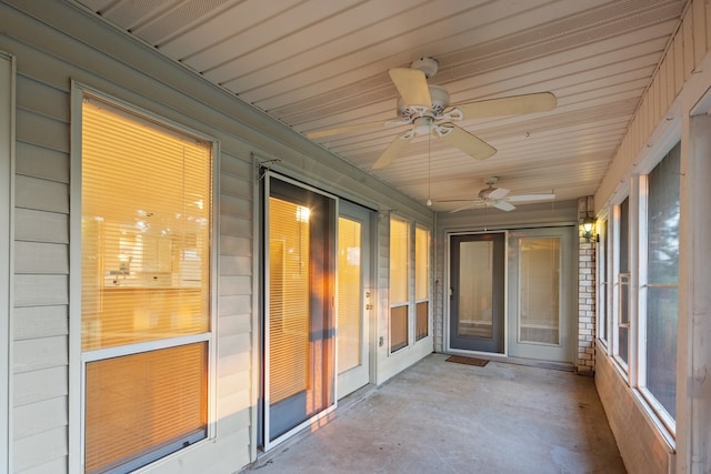 unfurnished sunroom with ceiling fan