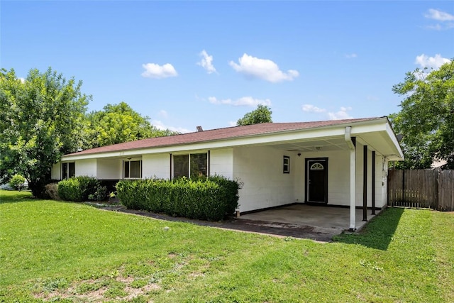 ranch-style house with a front yard and a carport