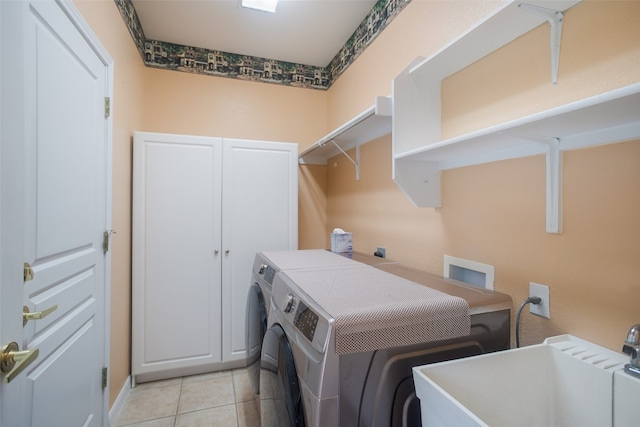 laundry room featuring sink, separate washer and dryer, and light tile patterned floors