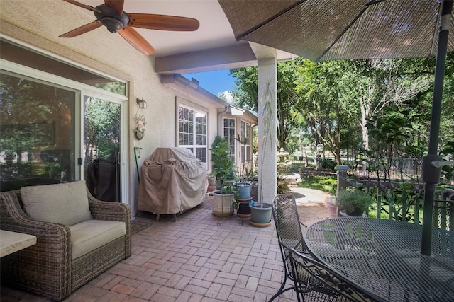 view of patio featuring ceiling fan and a grill