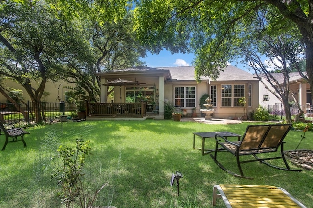 back of house with ceiling fan, a patio, and a lawn